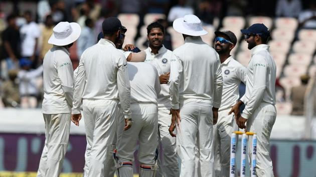 Indian cricketer Umesh Yadav (C) celebrates with his teammates for the wicket of West Indies cricketer Shane Dowrich during the first day's play of the second Test cricket match between India and West Indies at the Rajiv Gandhi International Cricket Stadium in Hyderabad. (AFP)