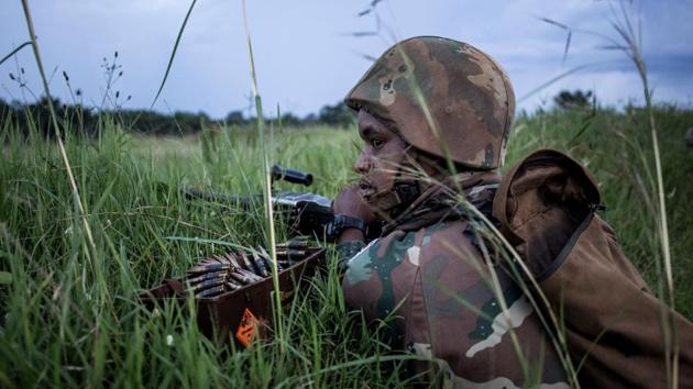 A South African soldier from the United Nations Stabilisation Mission in the Democratic Republic of the Congo (MONUSCO) takes his position as gun fire erupts close by outside Oicha. “I am always anticipating an attack,” said Maijeke, a soldier, of how it feels to be in the DRC’s “triangle of death”, as part of a UN peacekeeping force helping the Congolese army hunt down a militia group slaughtering civilians. (John Wessels / AFP)