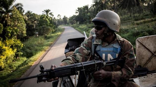 A MONUSCO soldier is seen during a patrol to hold off attacks by the ADF. One Friday, after reports of heavy mortar and machine gun fire, the troops headed to the town of Oicha, north of Beni and near the border with Uganda. The town’s residents greeted them by throwing stones. (John Wessels / AFP)