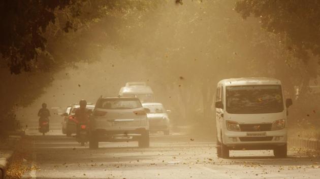 Commuters brave high dust levels and wind speeds in Sector 29, in Gurugram, Haryana. (Yogendra Kumar / HT Photo)