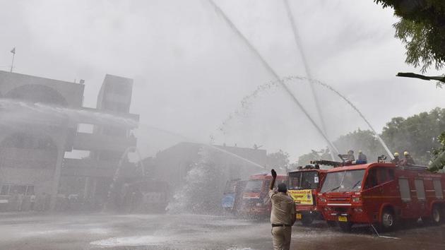 Firefighters take part in a safety drill on the occasion of ‘Fire Safety Week’ by Haryana Fire Service, at Sector-29, in Gurugram, Haryana. (Sanjeev Verma / HT Photo)