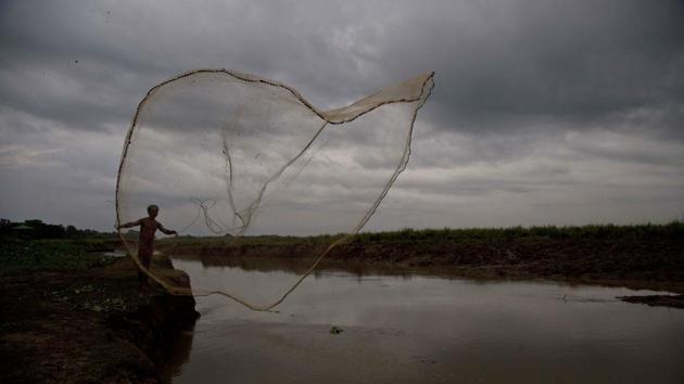 A fisherman casts his fishing net out for fish in Kaziranga, Assam. (Anupam Nath / AP)