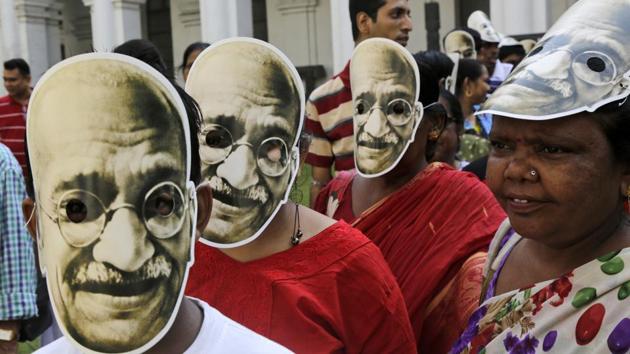School children and teachers wearing masks of Mahatma Gandhi, the father of the nation, participate in a rally to mark the independence leader's birth anniversary on October 2.(AP)
