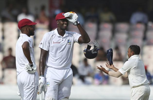 West Indies' cricket captain Jason Holder stands with his teammate Roston Chase during the first day of the second cricket test match between India and West Indies in Hyderabad (AP) West Indies' cricket captain Jason Holder stands with his teammate Roston Chase during the first day of the second cricket test match between India and West Indies in Hyderabad (AP)