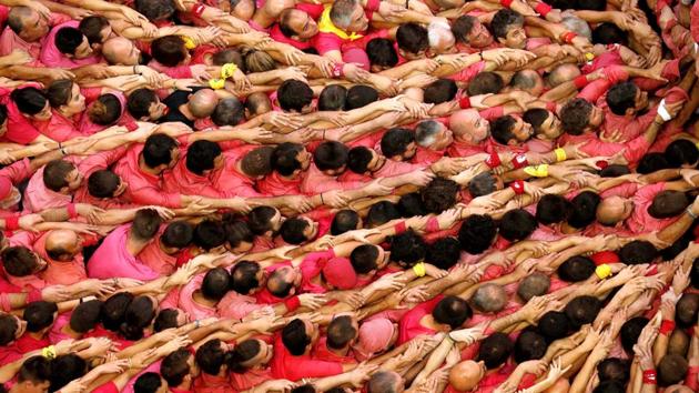 Members of group ‘Colla Vella dels Xiquets de Valls’ form a human tower called ‘castell’ during a biannual human tower competition in Tarragona, Spain. (Albert Gea / REUTERS)