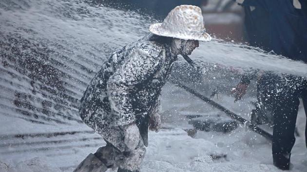 A firefighter is covered with Aqueous Film Forming Foam (AFFF) as he tries to control a fire that broke out in a thinner manufacturing plant on the outskirts of Ahmedabad, Gujarat. (Amit Dave / REUTERS)