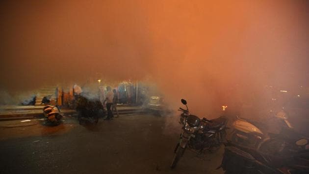 A municipal corporation worker fumigates to prevent mosquitoes from breeding at Pandav Nagar, East Delhi, India. (Raj K Raj / HT Photo)
