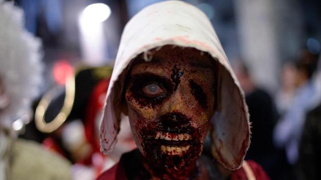 A woman sporting zombie make-up and dressed up as characters of the US TV series “The Handmaid’s Tale” takes part in the Zombie Walk event in the Catalan city of Sitges, within the framework of the 51st edition of the SITGES – International Fantastic Film Festival of Catalonia. (Josep Lago / AFP)