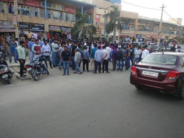 People gather at the site where the wife and son of an additional sessions judge were shot at outside Arcadia market in Sector 49, Gurugram on Saturday. (HT Photo) People gather at the site where the wife and son of an additional sessions judge were shot at outside Arcadia market in Sector 49, Gurugram on Saturday. (HT Photo)
