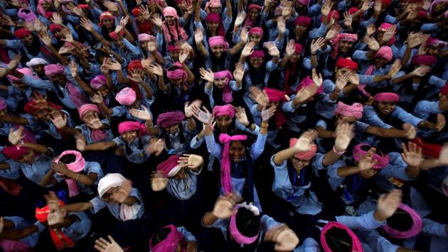 School girls wearing pink turbans wave during celebrations to mark International Day of the Girl Child 2018, at a school in Chandigarh. (Ajay Verma / REUTERS)