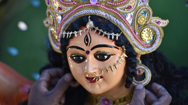 Mondol’s idols are known for his attention to detail, exquisite carving, brush work and beautiful colour scheme. He makes idols that will be revered, prayed to, smiled at and smeared with sindoor in the next few days. He says that sharing photos of idols on WhatsApp is also bringing more business for him. (Sanjeev Verma / HT Photo) 