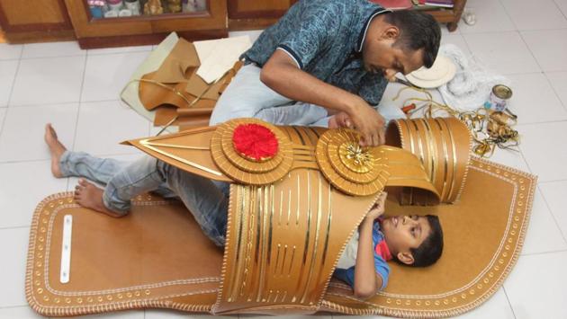Thane resident Ankush Karande, entered the Guinness book of world record by making a six feet Kolhapuri Chappal, the largest till date. Karande was helped by his son in making the footwear out of Italian leather with their bare hands in Thane, Maharashtra. (Praful Gangurde / HT Photo)