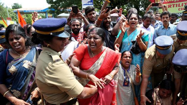 A woman reacts as she is detained by a police officer during a protest called by various Hindu organisations against the lifting of ban by Supreme Court that allowed entry of women of menstruating age to the Sabarimala temple, in Kochi, October 10(REUTERS) A woman reacts as she is detained by a police officer during a protest called by various Hindu organisations against the lifting of ban by Supreme Court that allowed entry of women of menstruating age to the Sabarimala temple, in Kochi, October 10(REUTERS)