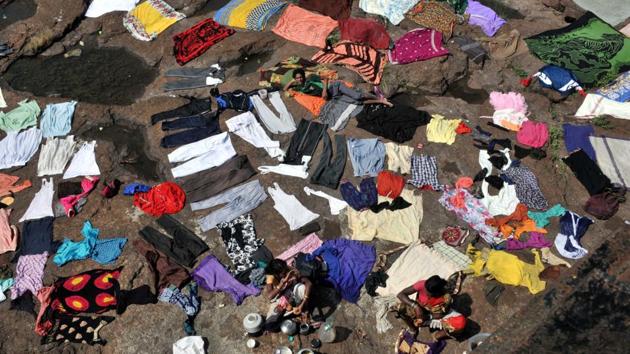 A view of washed clothes kept out to dry ahead of the Hindu festival Navratri, at Khadakwasla dam in Pune, Maharashtra. (HT Photo)