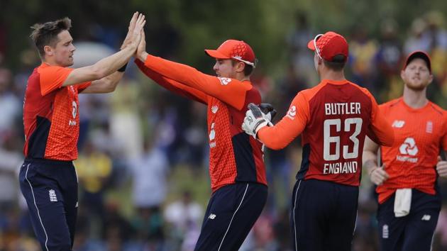 England's Chris Woakes, left, celebrates the dismissal of Sri Lanka's Dinesh Chandimal with his team mates during their second one-day international cricket match in Dambulla, Sri Lanka, Saturday, Oct. 13, 2018. (AP Photo/Eranga Jayawardena)(AP)