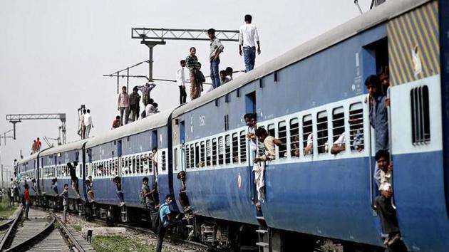 A file photo of passengers standing on top of an overcrowded train at Loni town in Uttar Pradesh. (Reuters photo)