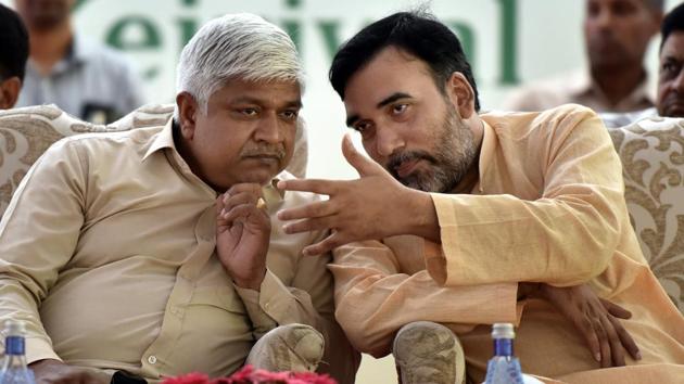 Delhi ministers Rajendra Pal Gautam (L) and Gopal Rai speak during a function in the national capital.(Sonu Mehta/HT PHOTO)