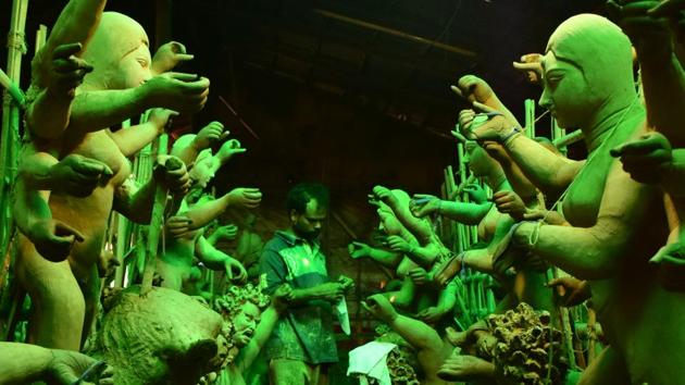 Dried in the sun, the idols are being readied for a coating of paint. Subhashish Adhikari, owner of a workshop says, “We are making 60 idols this time. The raw material comes from West Bengal. If we need more bamboo and mud, we get them from Delhi or Zirakpur. The costs of the idols range from ~ 20,000 to ~ 80,000.” (ANIL dayal)