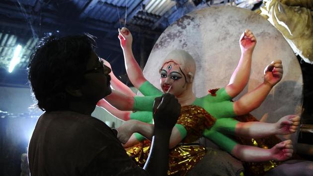 Durga’s eyes get lined with kohl before she gets her jewellery and lustrous curls. Chandi Das Halder, artist at the Sector 47 workshop, says,“ I design pandals too. It is my 24th year here. I stay here for five months before going home to work on idol designs,” he says. (ANIL dayal)
