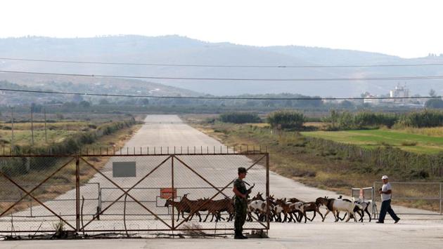 A shepherd passes by the airbase with his flock. Most days, sheep graze in the bushes between the taxiing lanes and the runway. Some 88 MiGs squat on their flat tires near three underground hangars, while birds sing around them. (Florion Goga / REUTERS) A shepherd passes by the airbase with his flock. Most days, sheep graze in the bushes between the taxiing lanes and the runway. Some 88 MiGs squat on their flat tires near three underground hangars, while birds sing around them. (Florion Goga / REUTERS)