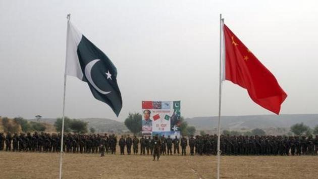 File photo of Pakistan and China's national flags fly in the foreground as soldiers from both countries stand together for a group shot after holding joint military exercises in Jhelum, located in Pakistan's Punjab province.(REUTERS)