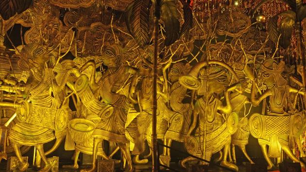 Created by artist Gouranga Kulia, the 84th Durga Puja pandal of South Kolkata’s Mudiali Club Sarbojanin is themed on Bengal’s intricate metal casting Dhokra folk art and Patachitra paintings. (Samir Jana / HT Photo) Created by artist Gouranga Kulia, the 84th Durga Puja pandal of South Kolkata’s Mudiali Club Sarbojanin is themed on Bengal’s intricate metal casting Dhokra folk art and Patachitra paintings. (Samir Jana / HT Photo)