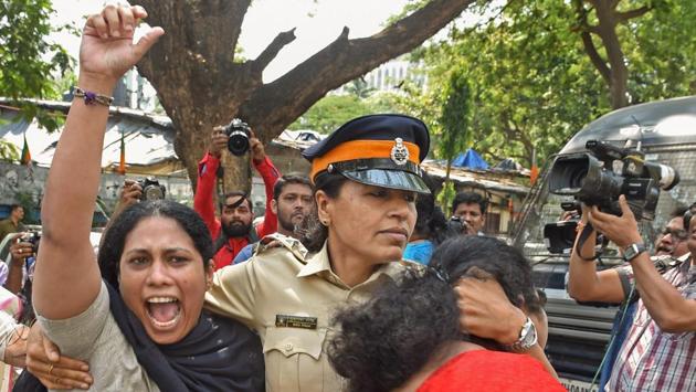 Police personnel detain Nationalist Congress Party (NCP) workers protesting against the rising prices of essential commodities outside the BJP office in Mumbai. (Shashank Parade / PTI)