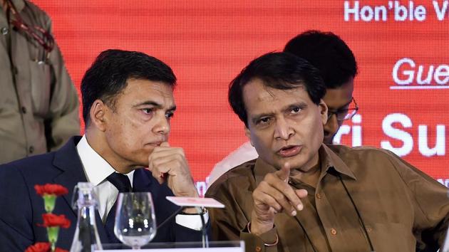 Commerce minister Suresh Prabhu speaks with JSW CMD Sajjan Jindal (L) during ASSOCHAM's 98th Annual Session ‘New India- Working For 1.25 Billion Aspirations’, in New Delhi.(AP Photo)