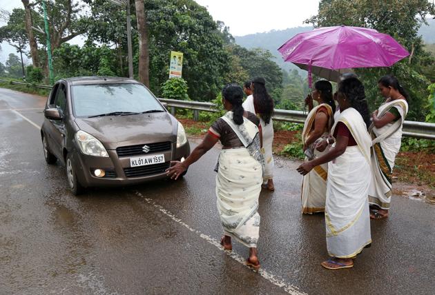 Devotees stop a car to check if any women of menstruating age are headed towards the Sabarimala temple, at Nilakkal Base camp in Pathanamthitta district, Kerala. (REUTERS) Devotees stop a car to check if any women of menstruating age are headed towards the Sabarimala temple, at Nilakkal Base camp in Pathanamthitta district, Kerala. (REUTERS)