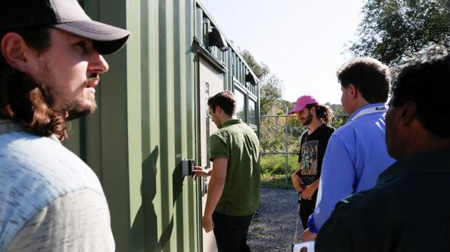 Students enter the shipping container which houses the marijuana lab. In brightly lighted climate-controlled rooms, protected by fences and layers of locked doors, are 50 cannabis clones that students will learn to irrigate, feed, protect, track with bar codes, test for chemical content, harvest and cure, said program coordinator Bill MacDonald. (Carlos Osorio / REUTERS) Students enter the shipping container which houses the marijuana lab. In brightly lighted climate-controlled rooms, protected by fences and layers of locked doors, are 50 cannabis clones that students will learn to irrigate, feed, protect, track with bar codes, test for chemical content, harvest and cure, said program coordinator Bill MacDonald. (Carlos Osorio / REUTERS)