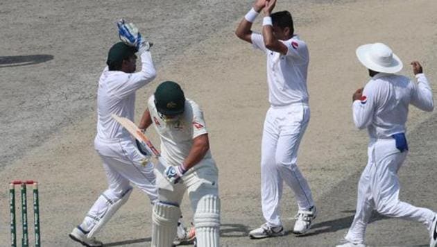 Pakistan cricketer Muhammad Abbas (2R) celebrates with teammates after taking the wicket of Australian batsman Aaron Finch.(AFP)