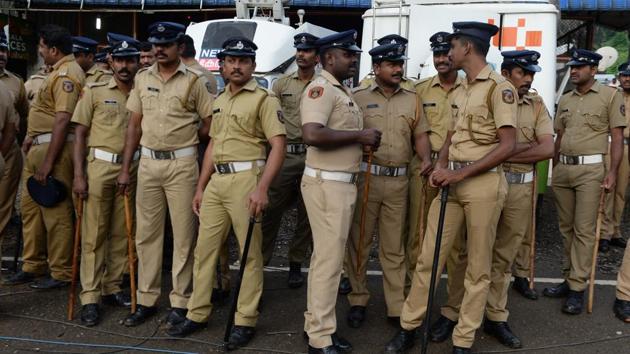 Policemen stand guard on Wednesday while devotees and activist protest against the Supreme Court verdict revoking a ban on women's entry to Sabarimala's Ayyappa temple, in Nilakkal in Kerala. (AFP) Policemen stand guard on Wednesday while devotees and activist protest against the Supreme Court verdict revoking a ban on women's entry to Sabarimala's Ayyappa temple, in Nilakkal in Kerala. (AFP)
