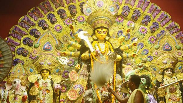 Devotees perform prayers during Maha Asthmi puja at Shyam Square Durga Puja in Shyambazar in North Kolkata. (Samir Jana / HT Photo)