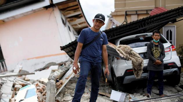Government officer, Yassir Garibaldi, in front of his parents’ house. “I bought this car for my parents,” he said. “It’s the only thing of theirs I have now.” He recounted watching his parents and niece suffocate to death. “I found them in the morning after the earthquake. I managed to speak with them, even gave them some water to drink,” he said. “But they were crushed against each other... After a while, they just stopped breathing.” (Jorge Silva / REUTERS)