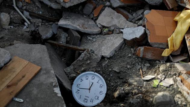 A stopped clock shows the time a few minutes after the earthquake, lying among rubble. Some however, remain inconsolable. “I don’t know what to do next. There’s nothing left for me here,” said Kaharuddin, the fruit vendor still looking for his daughter’s body under the pink concrete rubble of their former home. (Jorge Silva / REUTERS)
