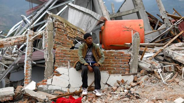 Nofal Surya, 37, sits on bricks that used to be his home. Surya said he lost around 15 members of his extended family and only seven have been found. “If I want to follow my heart, of course I want the search to keep going. But I think I have to accept that I may never find them. I understand it’s very hard now and that it’s not good for health,” he said. (Jorge Silva / REUTERS)