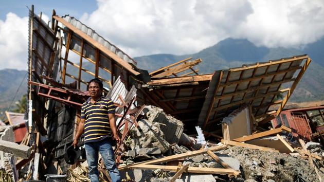 Wooden beams tilted at crazy angles poke out of piles of shattered concrete littered with battered motorbikes and household items, from crumpled pots and pans to smudged notebooks and soft toys. After the magnitude 7.5 earthquake hit Indonesia’s coastal city of Palu, a pile of broken pink concrete is all that remains of fruit vendor Kaharuddin’s home. (Jorge Silva / REUTERS)
