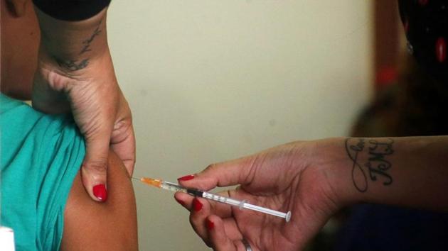 A woman is vaccinated during a campaign against yellow fever, dengue, chikungunya and zika after the World Health Organization issued recommendations for travellers heading to certain parts of Brazil and Southeast Asia, in Buenos Aires, Argentina. (Marcos Brindicci / REUTERS)