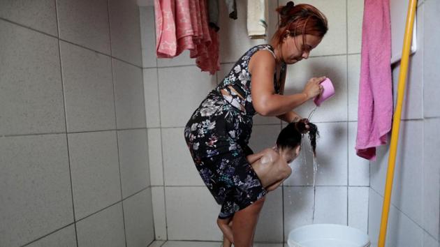 Many of the women have largely adjusted to the initial shock of their child’s disability, trading dreams of their own careers for the reality of around-the-clock care of a child who may never walk or talk. They struggle to get by on a monthly disability check of just over 954 reais (roughly $250), which must cover shelter, food, medications and frequent doctor visits. (Ueslei Marcelino / REUTERS)