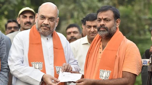 Swami Paripoornanda joined the BJP in the presence of its president Amit Shah on Friday. (Sonu Mehta/HT Photo) Swami Paripoornanda joined the BJP in the presence of its president Amit Shah on Friday. (Sonu Mehta/HT Photo)