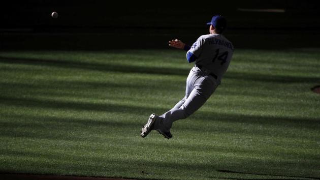 Los Angeles Dodgers center fielder Enrique Hernandez (14) fields a grounder by Milwaukee Brewers’ Lorenzo Cain during the first inning of Game 2 of the National League Championship Series baseball game, in Milwaukee. (Charlie Reidel / AP)