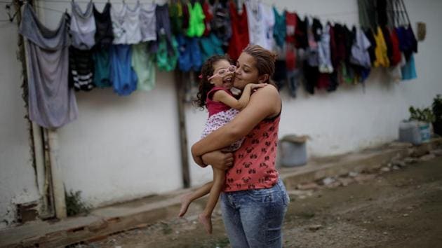 Gabriela Alves de Azevedo, 22, holds her two-year-old daughter Ana Sophia at their house in Olinda. Ana Sophia has microcephaly, a rare birth defect marked by small head size that signifies arrested brain development during gestation. Besides developmental issues, Ana Sophia has vision and hearing problems and trouble swallowing. Gabriela had planned to finish high school and study physical therapy. Now, she spends her days caring for her child. (Ueslei Marcelino / REUTERS)