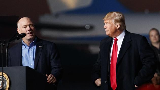 Congressman Greg Gianforte (left) speaks as President Donald Trump stands right during a campaign rally at Minuteman Aviation Hangar, Thursday, Oct. 18, 2018, in Missoula, Montana. (AP)