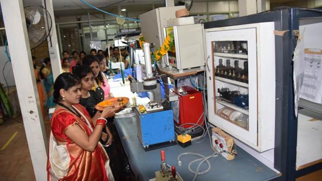 Women perform puja of machines and equipment on the occasion of khande navmi (ninth day prayer) at Four Front Private Limited MIDC Chinchwad on Wednesday. (HT PHOTO) Women perform puja of machines and equipment on the occasion of khande navmi (ninth day prayer) at Four Front Private Limited MIDC Chinchwad on Wednesday. (HT PHOTO)