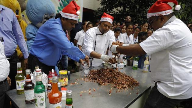 A Christmas cake mixing ceremony was held at Chaitanya Institute for mental health centre, Kondhwa, on Wednesday. Traditional cake mixing ceremony kicks off a few months before Christmas. The activity involves mixing liquor and dry fruits along with spices. It is soaked for three-four weeks and then baked. The alcohol, being in a liquid form, has a tendency to settle down in the jar and to ensure even soaking and absorbing of liquor by the fruits, the sealed mix is opened once a week to be mixed properly again. (RAHUL RAUT/HT PHOTO) A Christmas cake mixing ceremony was held at Chaitanya Institute for mental health centre, Kondhwa, on Wednesday. Traditional cake mixing ceremony kicks off a few months before Christmas. The activity involves mixing liquor and dry fruits along with spices. It is soaked for three-four weeks and then baked. The alcohol, being in a liquid form, has a tendency to settle down in the jar and to ensure even soaking and absorbing of liquor by the fruits, the sealed mix is opened once a week to be mixed properly again. (RAHUL RAUT/HT PHOTO)