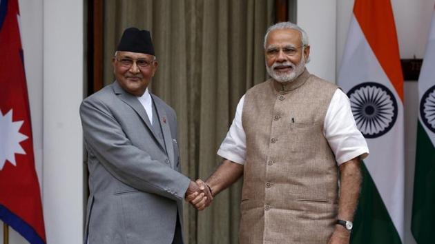 Nepal's Prime Minister Khadga Prasad Sharma Oli (L) shakes hands with his Indian counterpart Narendra Modi in New Delhi.(REUTERS FILE PHOTO)