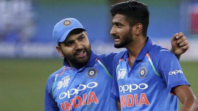 India's Khaleel Ahmed (R), right, gets a pat from captain Rohit Sharma after dismissing Hong Kong's Ehsan Khan during the one day international cricket match of Asia Cup between India and Hong Kong.(AP)