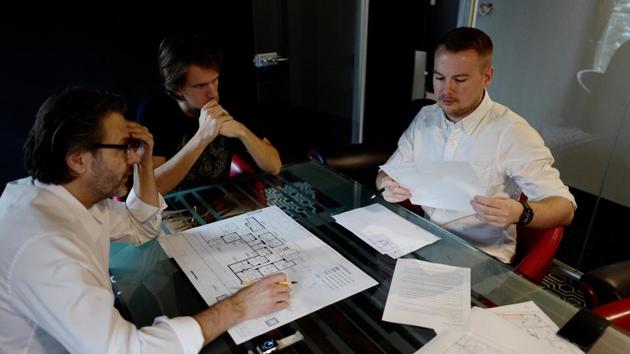 Recruit Damian Krasnodebski, (R), an architect, works with his boss on a project. He says the force will provide guerrilla fighters to help deter potential attackers, particularly Russia. “A guerrilla force is always difficult to fight against,” he said. “If there was fighting in Poland, there would be problems with supply lines, subversive activity. That’s always difficult for the opposing military.” (Kacper Pempel / REUTERS)