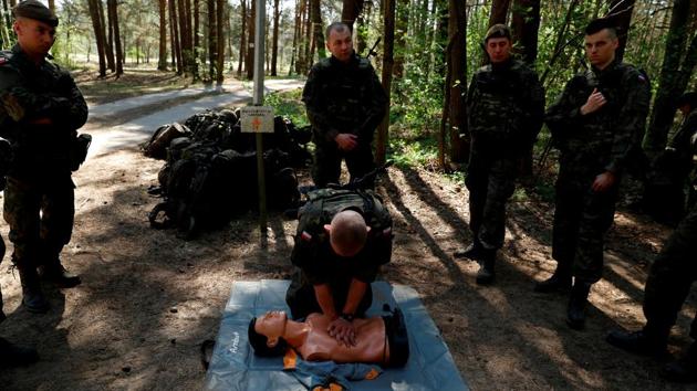Territorial soldiers practice first aid. Young people who join are expected to spend at least four months in training over three years, including 16 days in basic training in battlefield readiness, marksmanship, topography and first aid. Any holiday trips need to be cleared with a local unit commander. In return, recruits receive a 300 zloty ($80) monthly stipend as well as education and training allowances. (Kacper Pempel / REUTERS)
