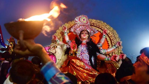 Devotees carry an idol of Goddess Durga for immersion in a pond near Ganges River. (PTI) Devotees carry an idol of Goddess Durga for immersion in a pond near Ganges River. (PTI)